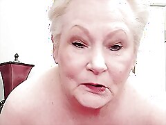 An older woman with a wide vagina gets pleasure from a dildo, moaning and shaking.